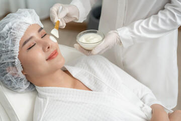 Beautiful woman receive spa and treatment skin of face. face of a healthy woman apply cream....
