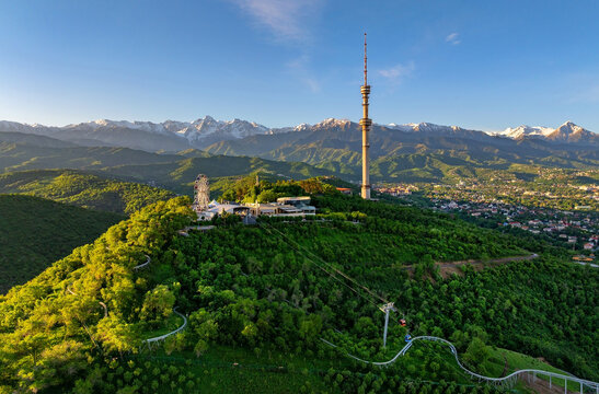 Mount Kok Tobe (Blue Hill) with the famous TV tower against the backdrop of the Zailiyskiy Alatau mountain range in the Kazakh city of Almaty on an early spring morning