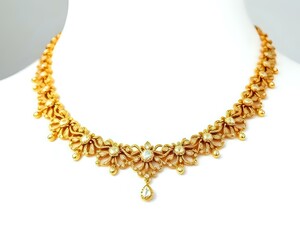 Obraz premium gold necklace isolated on white background