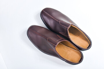 Brown leather slippers isolated on white background
