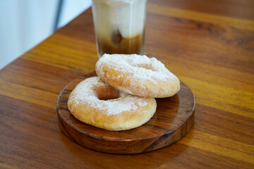 Sugar-coated donut at a café, captured on May 12, 2025. Soft and fluffy texture with a sweet sugar...