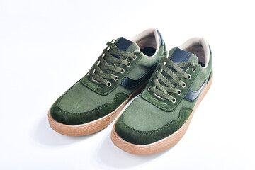 Casual style shoes made of green canvas fabric isolated on white background
