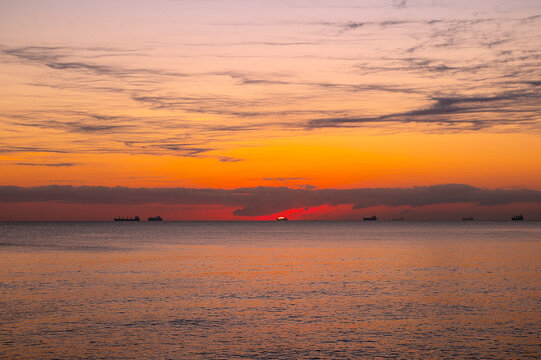 Beautiful sunrise in Veracruz, Mexico. The sun illuminates the Gulf of Mexico sky with warm tones. - Powered by Adobe