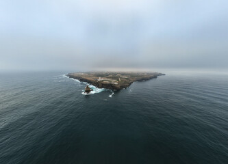 Fototapeta premium Wide drone view of Cabo Carvoeiro cape extending into the Atlantic Ocean