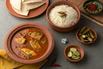 Bengali Rui Macher Jhol with Rice in Terracotta Plate – Traditional Fish Curry Top View