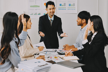 Team of financial advisory services. Asian advisor showing plan of investment to clients in the consultancy office..