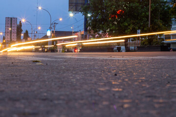 Cinematic street photography at dusk with warm ambient urban lighting glow