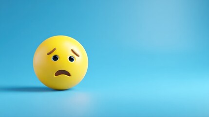Yellow sad emoji ball on blue background expressing negative emotion.