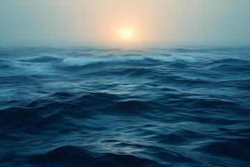 Obraz premium Misty ocean sunrise with waves.