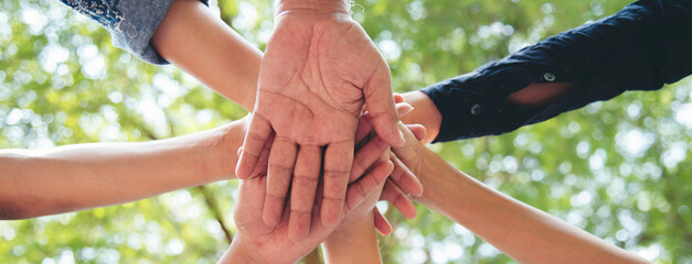 Banner diversity solidarity team multiethnic Partners hands together teamwork. Group of multiracial...