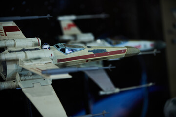 Naklejka premium A fleet of X-wing fighter figures arranged in outer space setup in San Salvador, May 4 2025, celebrating Star Wars Day.