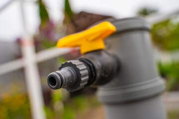 Adapter for quick connection of water hose in a country area. Water tap on the street, close-up