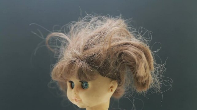 old doll rotating with grey background, bad hair day