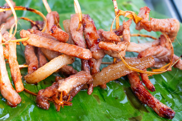 Fried pork on bamboo skewers is a Thai street food