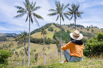 Tourist admiring La Samaria Valley with wax palm trees in Salamina, Colombia