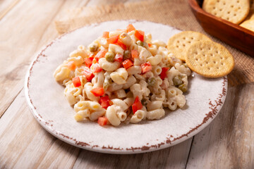 Macaroni salad with elbow pasta and canned tuna, served with saltine crackers. Easy and healthy recipe.