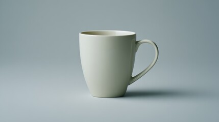 A plain white ceramic mug sits on a minimal neutral background, emphasizing its simplicity and elegance, with ample copy space available for design elements