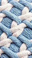 Close-up of a knitted fabric with blue and white interwoven cables