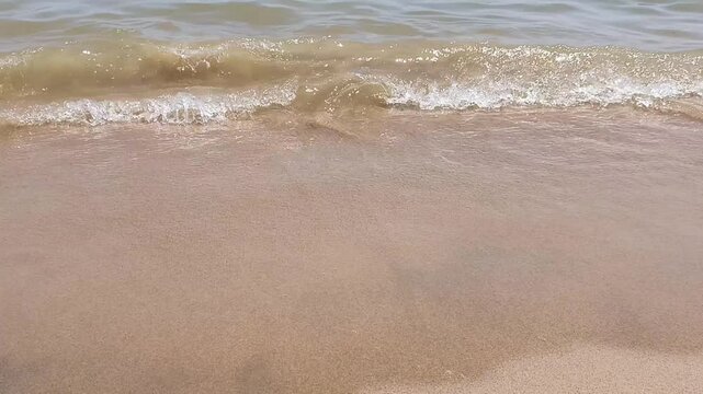 Gentle Ocean Waves on a Smooth Sandy Shore