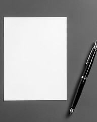 A white sheet of paper on the table with a black fountain pen next to it, top view, flat lay.
