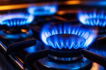 Gas burners ignited with blue flames on a modern stove  