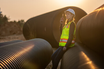 Construction surveyor or engineer working in pipe construction site for inspection detail of...
