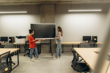 Collaborative Work Environment with Two Women Engaging in a Workplace Discussion