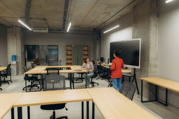 Modern Office Space With Two Women Collaborating on a Project
