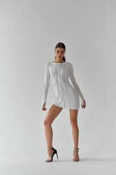 Woman in White Dress and High Heels Posing in Studio