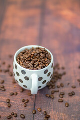 Fresh organic raw coffee beans in a mug