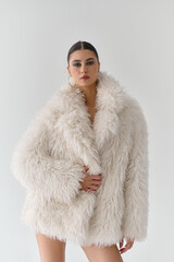 Elegant Woman in a Fur Coat, in a studio