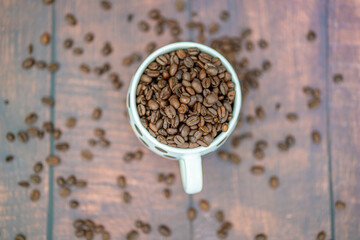 Fresh organic raw coffee beans in a mug
