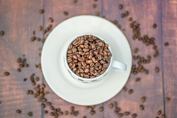 Fresh organic raw coffee beans in a mug