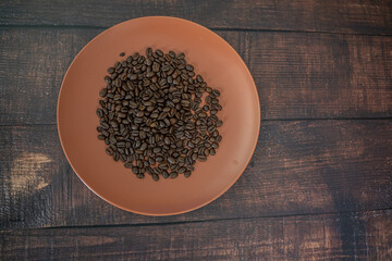 Fresh organic raw coffee beans on a plate
