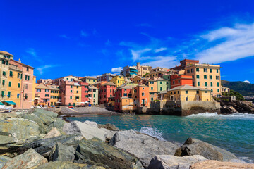 Picturesque view of beach, blue sea and colorful buildings of Boccadasse, old fishing village, in...
