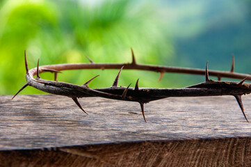 A wooden table beneath a thorny crown paints the humility and endurance of Christ passion and...
