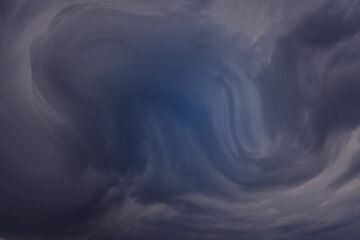 Dark, threatening background resembling a huge wave, hurricane, storm.