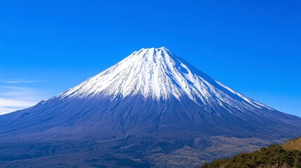 Majestic Snow-Capped Mountain Under Bright Blue Sky in Scenic Landscape