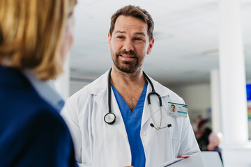 Female medical sales representative presenting medication to doctor