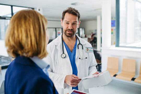 Female medical sales representative presenting medication to doctor