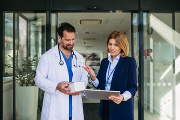 Confident female medical sales representative introducing pharmaceutical products to doctor.