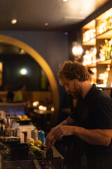 Bartender makes cocktails in a night bar