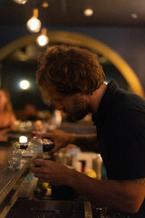 Bartender makes cocktails in a night bar