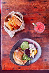 Overhead view of Mexican food meal on wood table