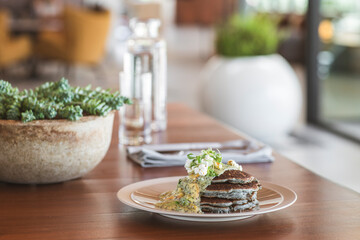 Blue corn pancakes with creamy sauce and garnish