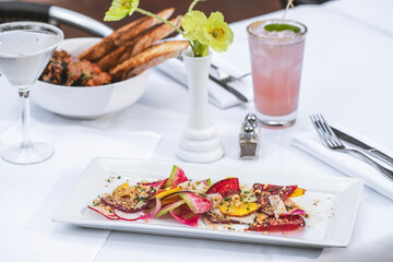 Salad and food spreda with drinks on white table