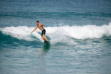 Surfer turns on a small wave in Hawaii