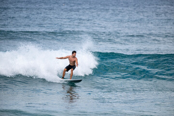 Male surfer cuts back on wave in Hawaii