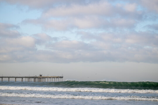 Wave breaks with Ocean Beach pier in background