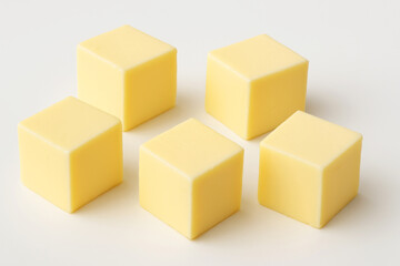 Fototapeta premium Fresh Yellow Butter Cubes Arranged on a White Background for Culinary Presentation